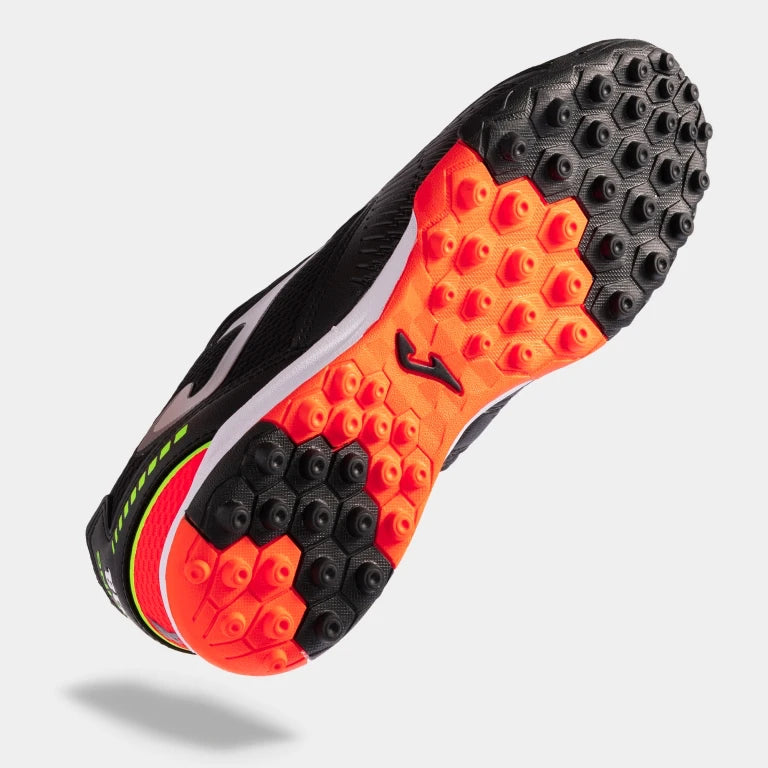 Joma Dribling 2301 black soccer shoes – bottom view of rubber turf outsole with short studs for traction on synthetic surfaces.