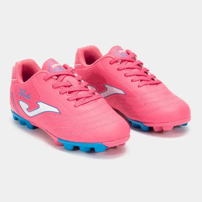 Pink soccer shoes with blue cleats on front view