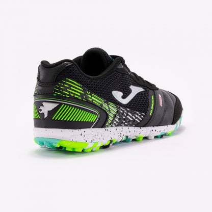 Joma Mundial 2401 black soccer shoes worn on turf field – demonstrating fit and performance grip on synthetic surfaces.