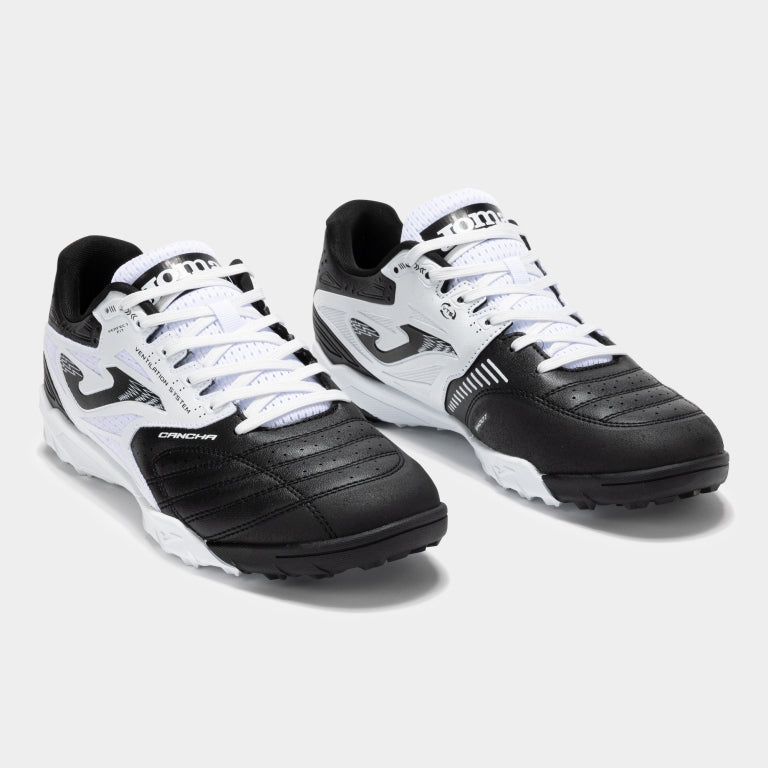Joma Cancha 2501 white turf soccer shoes worn on synthetic field – showing fit, comfort, and grip