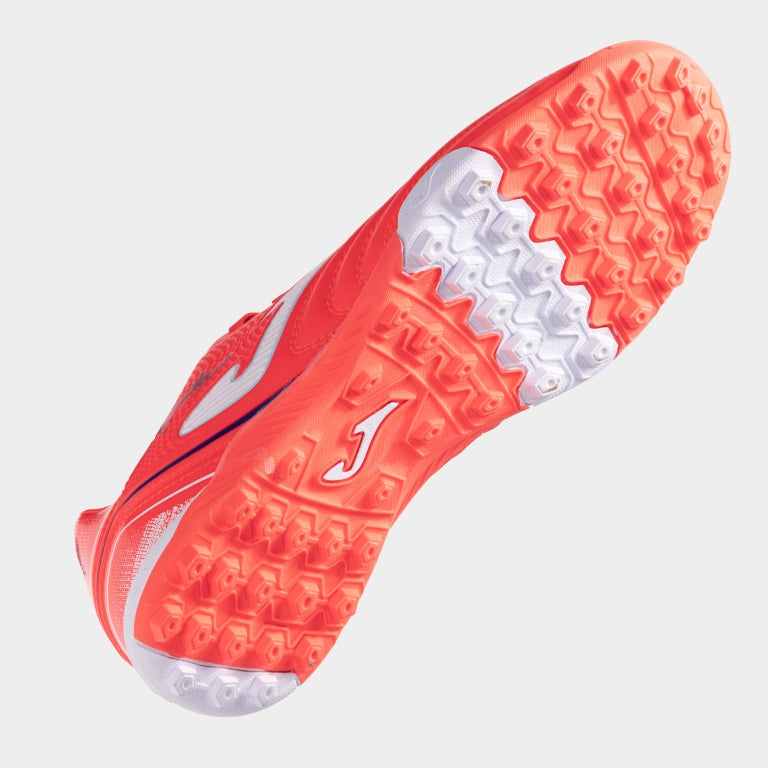Joma Aguila 2507 orange soccer shoes – bottom view of rubber turf outsole with short studs for traction on synthetic fields.