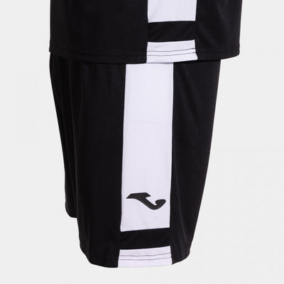 Black and white sports shorts with a brand logo on a light gray background