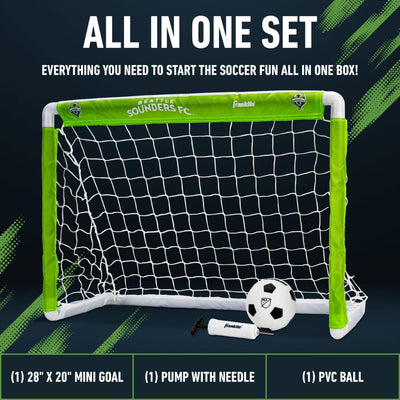 Mini soccer goal set with ball and pump on a dark background