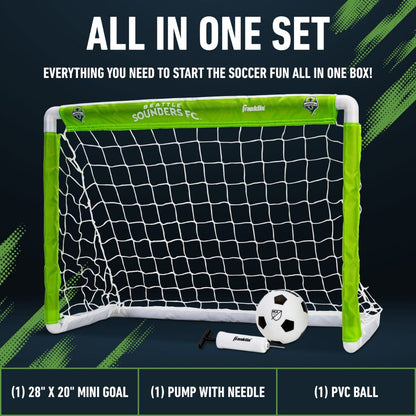 Mini soccer goal set with ball and pump on a dark background